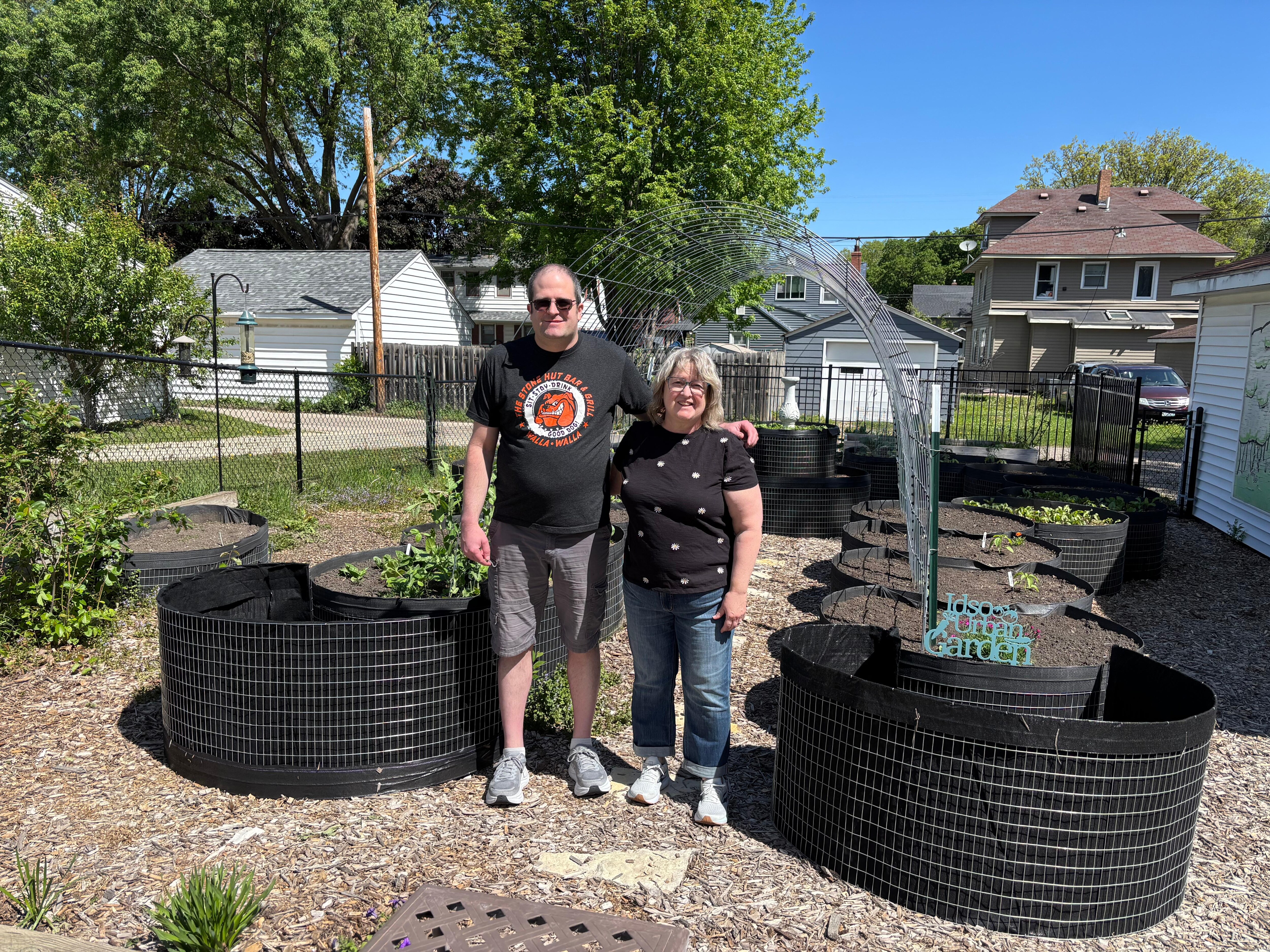 Christine Coy and son Robert White in the backyard garden.