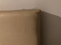 Paint peeling and wood pulling away from wall