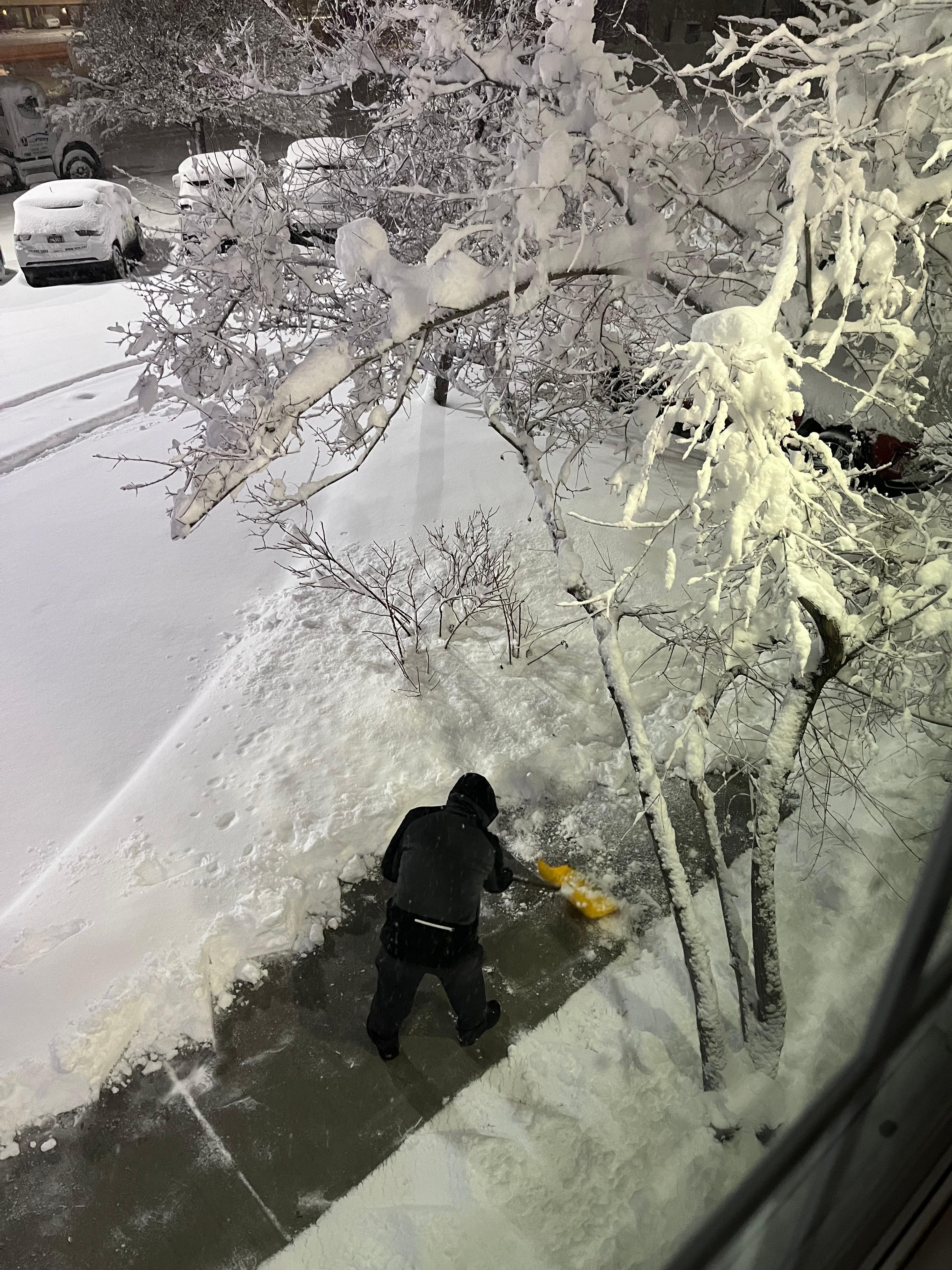 Gentlemen clearing the sidewalk below our window 
