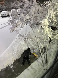 Gentlemen clearing the sidewalk below our window