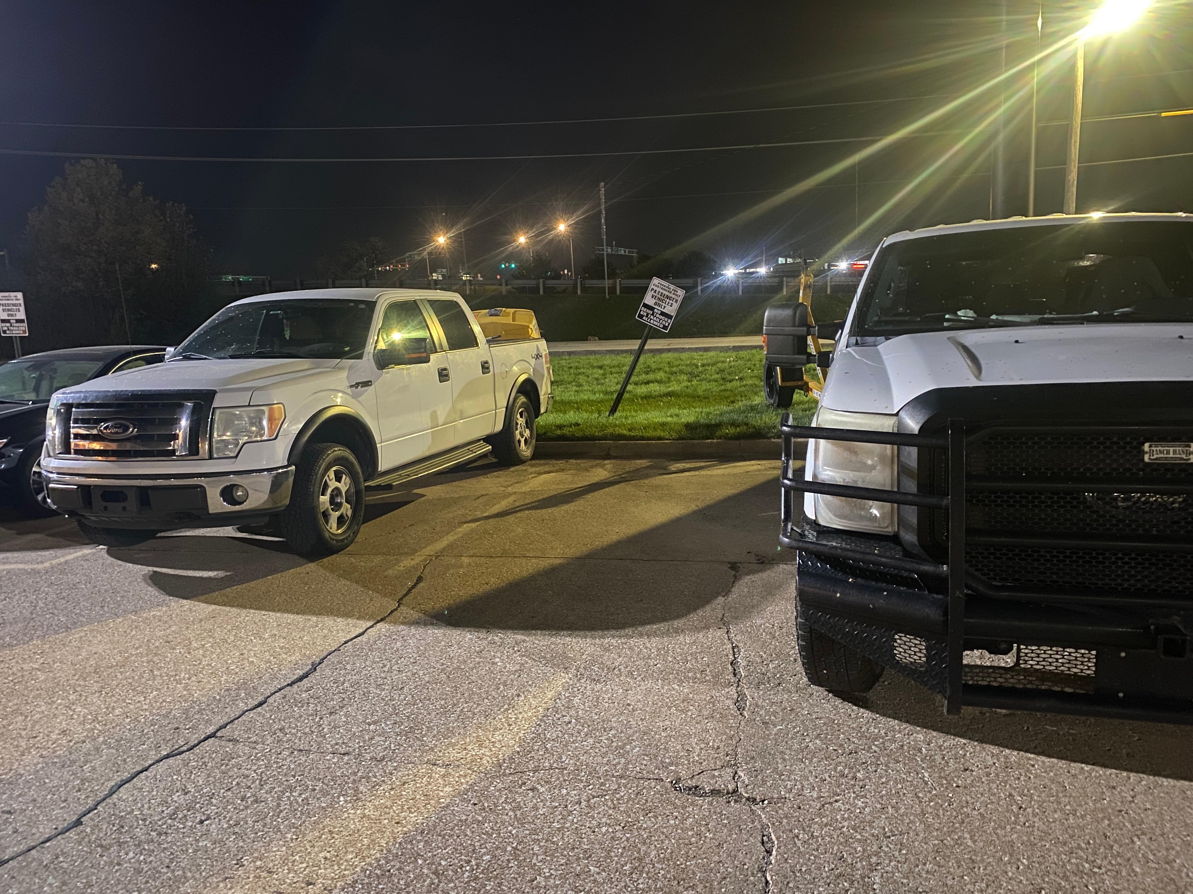 Notice the sign in background pushed sideways (likely from a large truck or trailer) clearly stating passenger vehicles only
