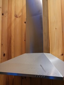 obvious layer of dust on kitchen hood ( finger streak mark added for photo to show how dusty)