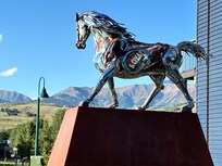 Arts center sculpture a couple blocks away with mountains in background.
