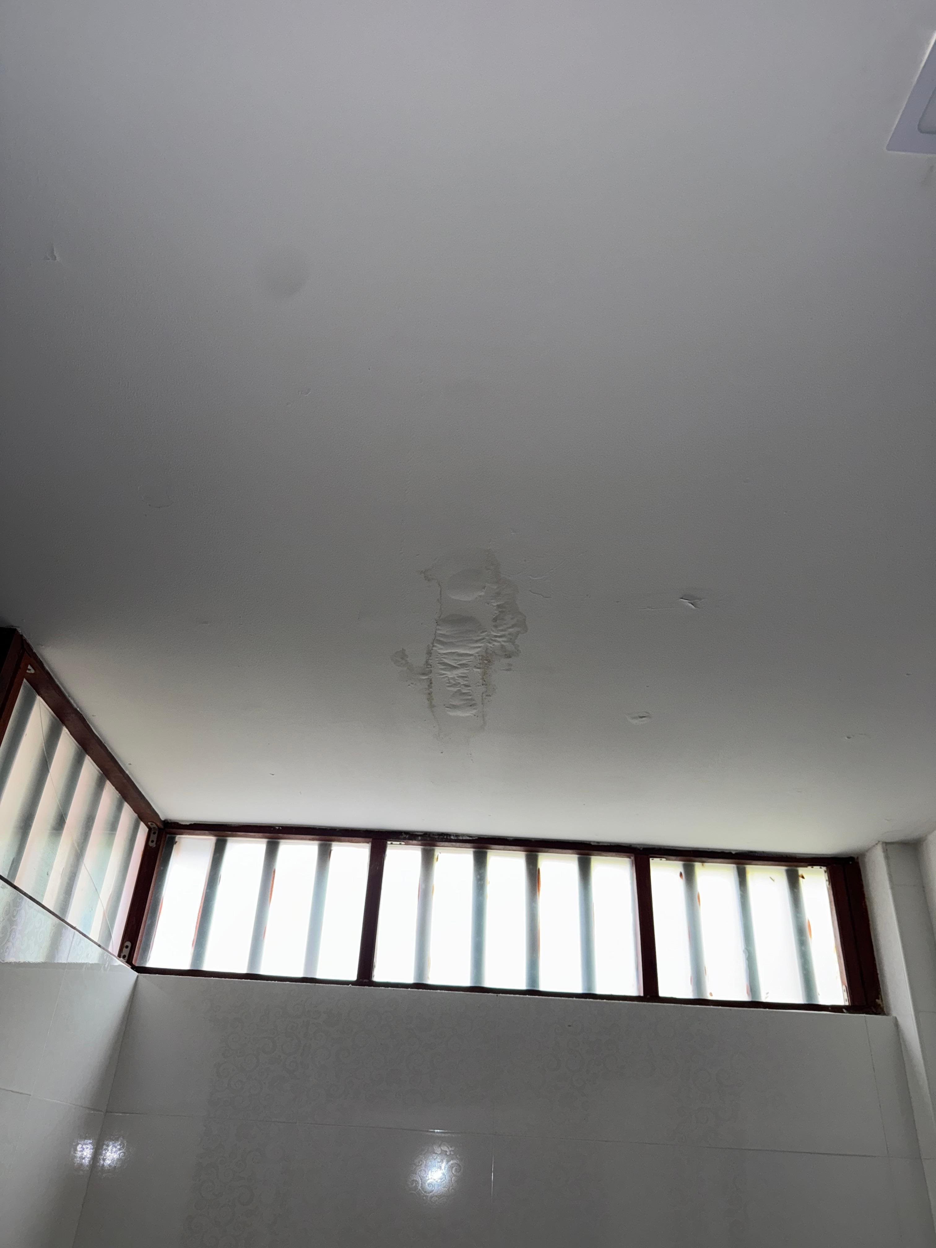Broke window and ceiling stains 