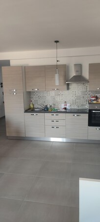 kitchen, fully equipped, there are some rubbish bags, broom etc