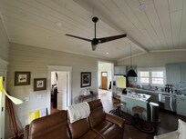 From the living room towards the front entryway. Kitchen and downstairs bedroom entrance