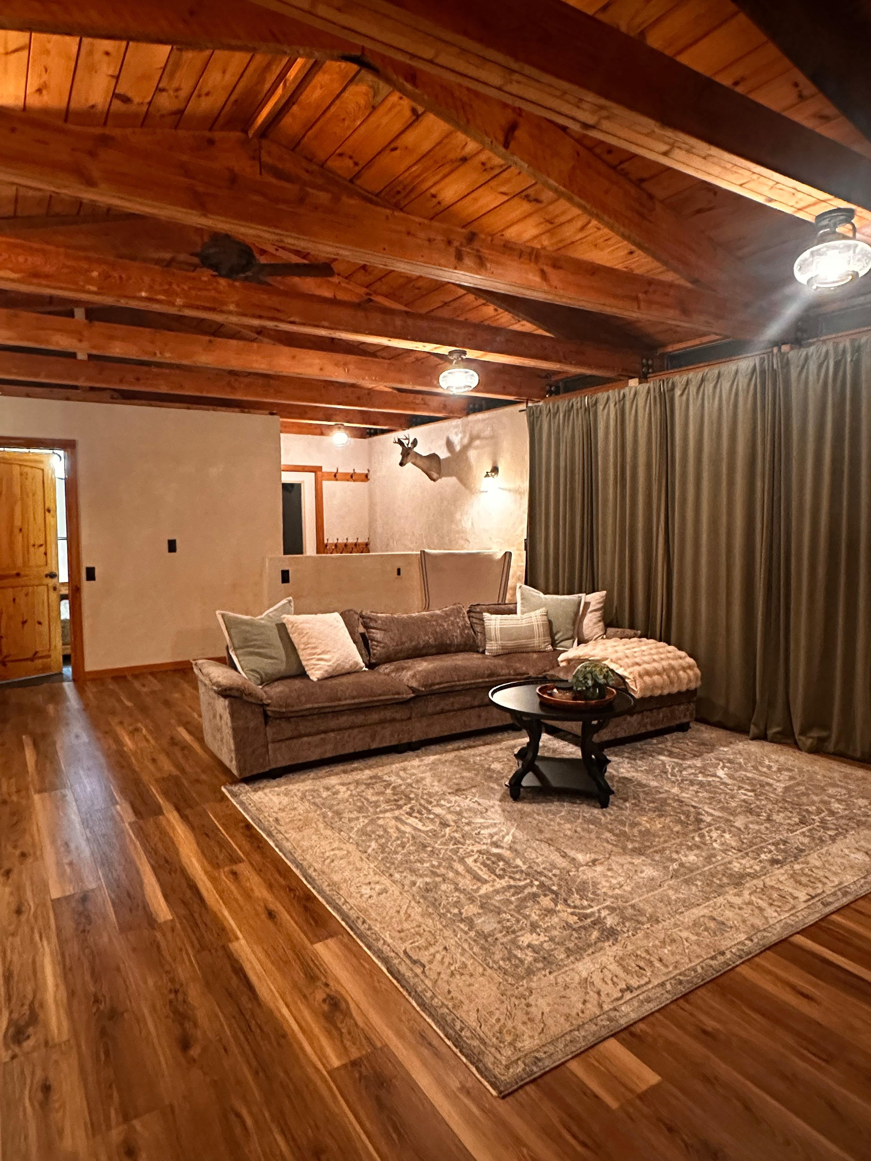 That sofa is gorgeous, clean and comfortable for laying around to watch TV. There are full length curtains to close at night, over the sliding doors.