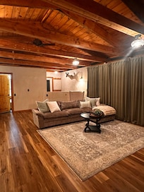 That sofa is gorgeous, clean and comfortable for laying around to watch TV. There are full length curtains to close at night, over the sliding doors.