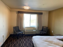 No lamps, desk, dresser, or table and just sparse.