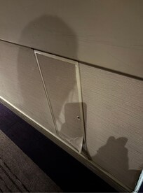 Panel peeling on corridor wall.