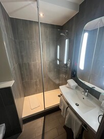 Restroom was clean & spacious. The shower has no door and gets really cold & slippery on that first landing spot. Additionally, if you’re tall like us (6’-6’4”) prepare for your knees to be up & on the wall when you use the toilet! Lol