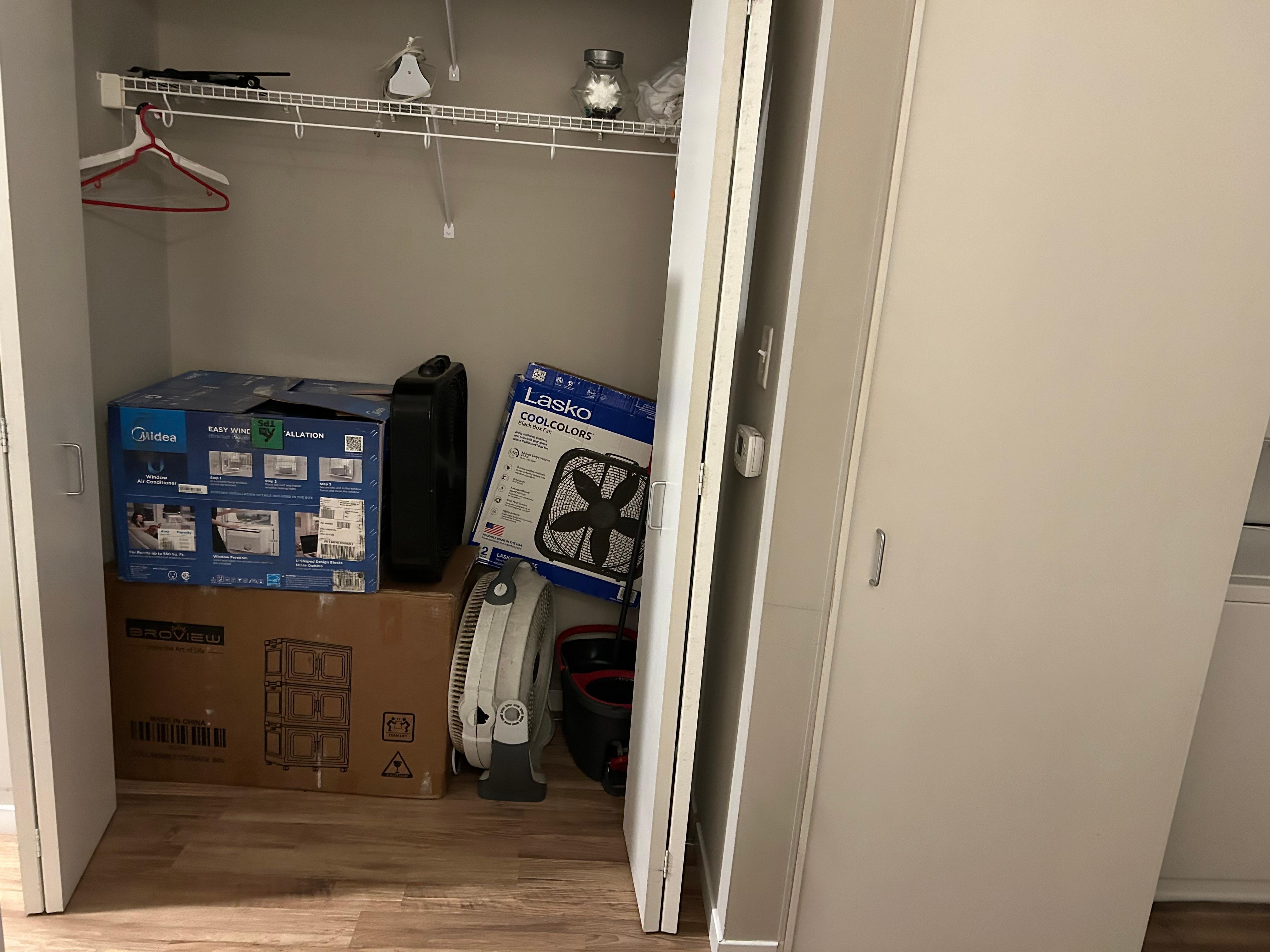 No dresser in bedroom so this was the only place to hang clothes. Only 2 hangers available. Junk piled up to within a couple of feet from the shelf. Other stuff on the shelf. The whole place was substandard. 