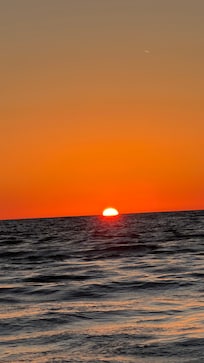 Sunsets from the beach or a boat. Must not be missed