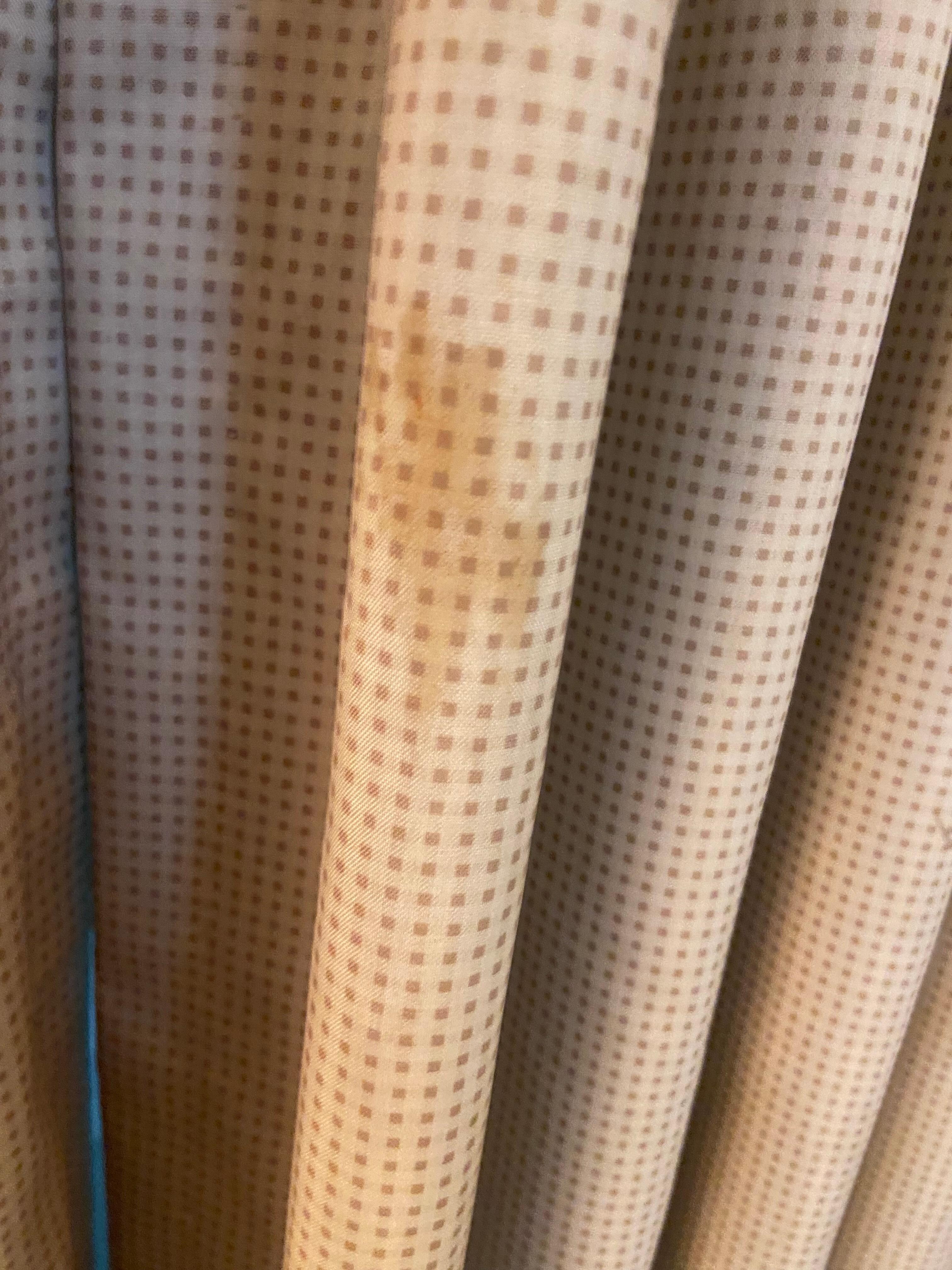 Stains or mold on curtains. Not shadows as one might claim.