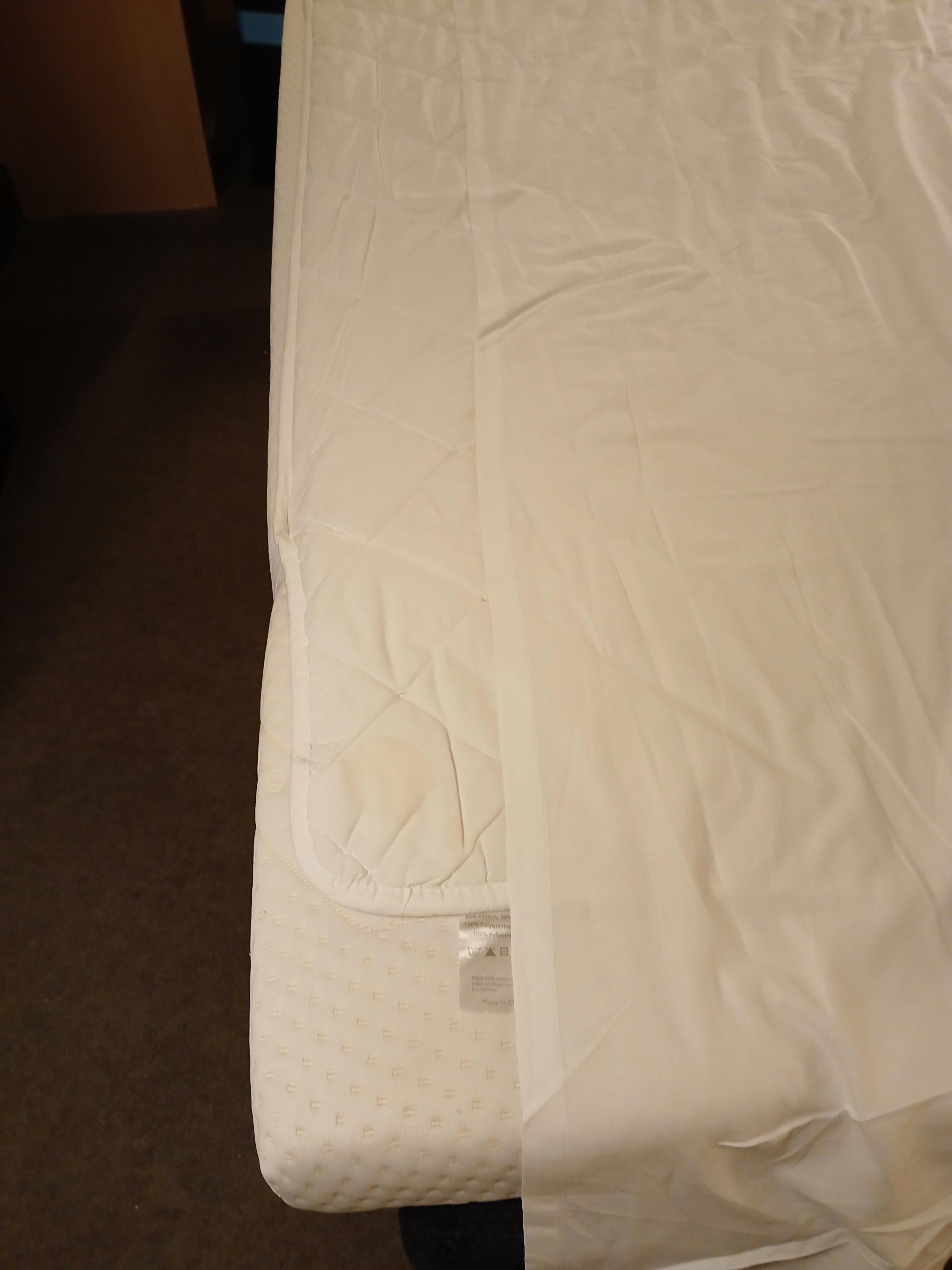 Sheet too short and mattress topper didn't stay in place, overhanging the base.