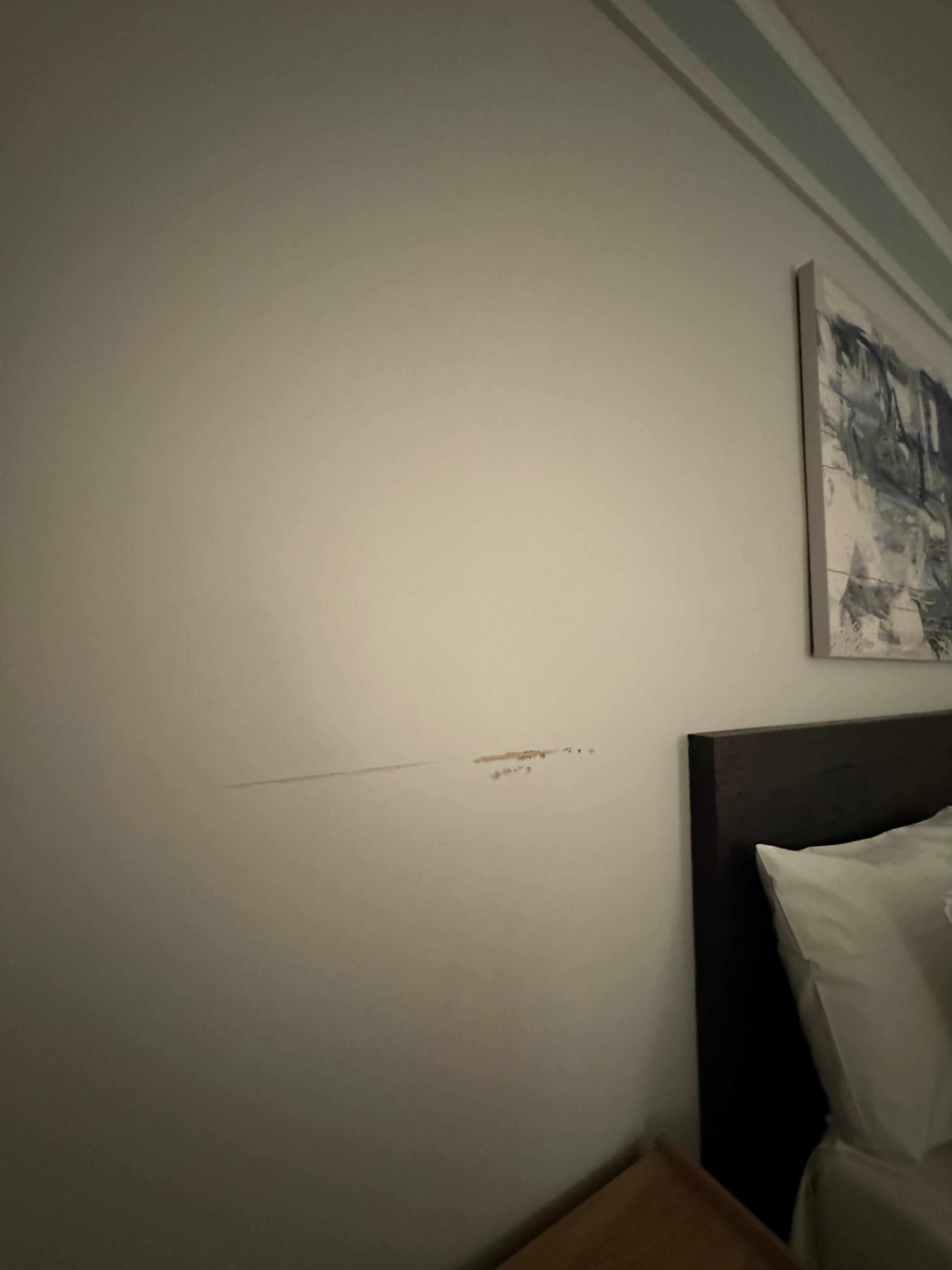 Random scrapes on the wall? Also there was an awful amount of empty space in the room. Almost looks like it used to be two beds in the room