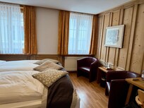 Ample bedroom.  Be careful of the threshold.  I tripped and flying into the room. Failed to mention the attention to detail.  In the closet in a tiny little box was an adapter for the local outlet, a flashlight and an umbrella for the guests’ use!!!!