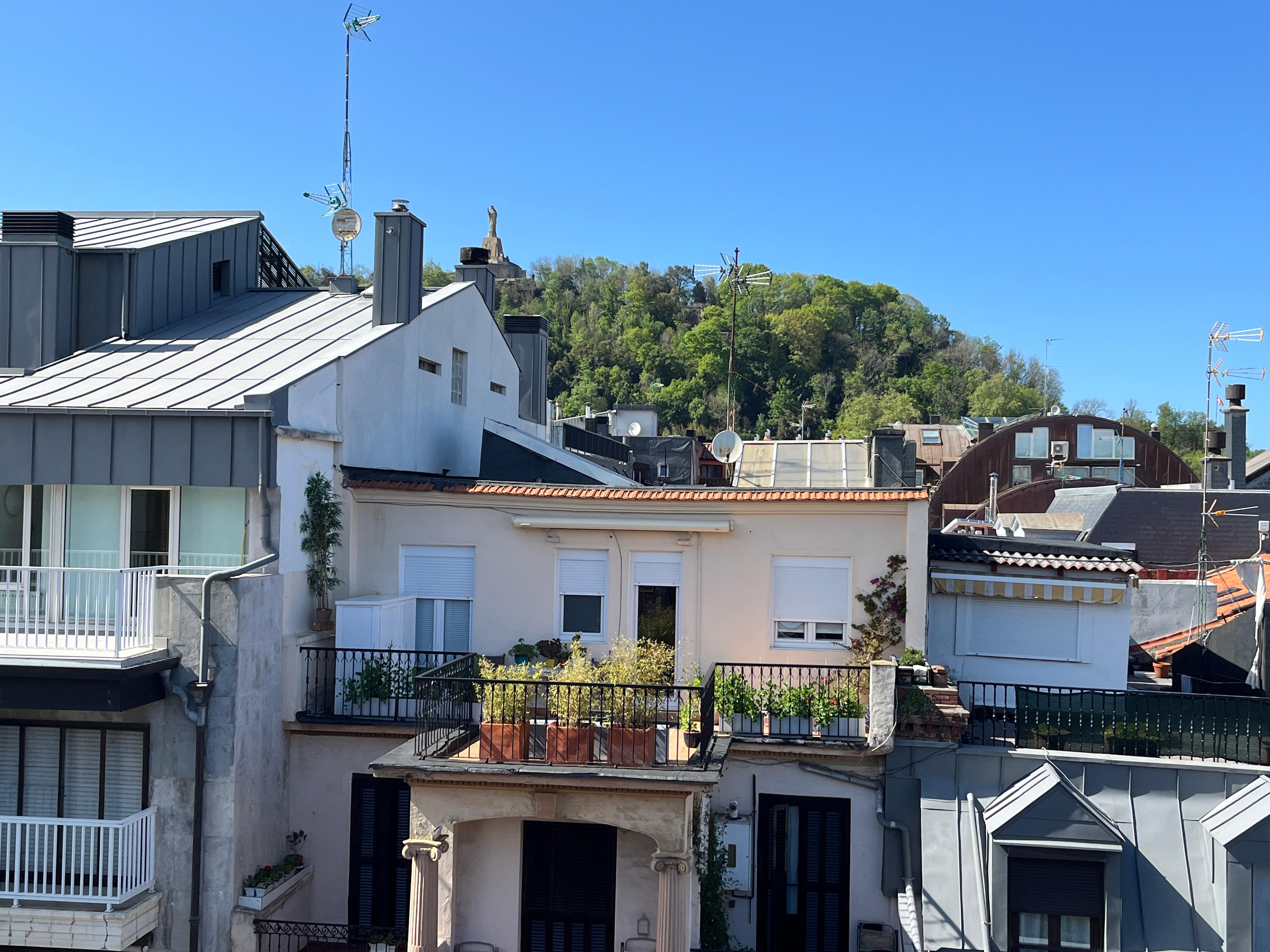 balcony view of Sacre Couer atop Mount Urguall