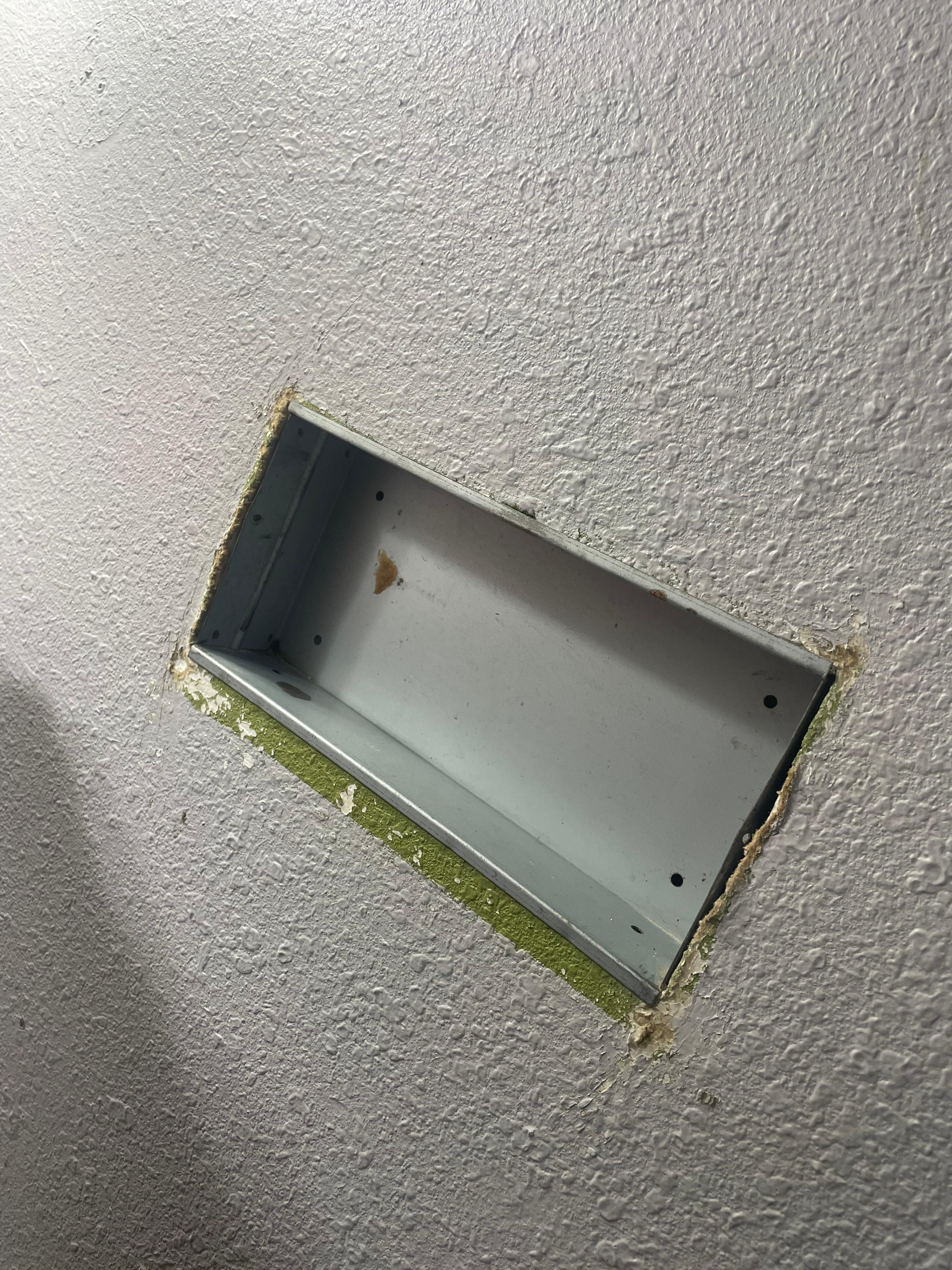 To the right of the sink this random empty panel in the wall for seemingly no reason