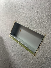To the right of the sink this random empty panel in the wall for seemingly no reason