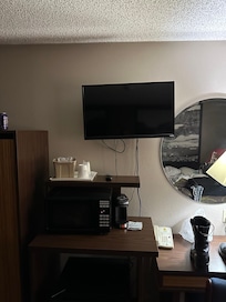 Tiny and unlevel tv with wires hanging out