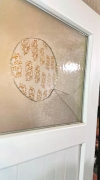 The washroom door with no privacy, even the glass is broken