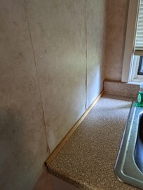 Kitchen wallpaper also peeling.