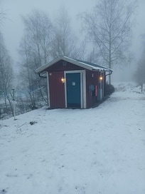 The toilet and shower separated from the cottage