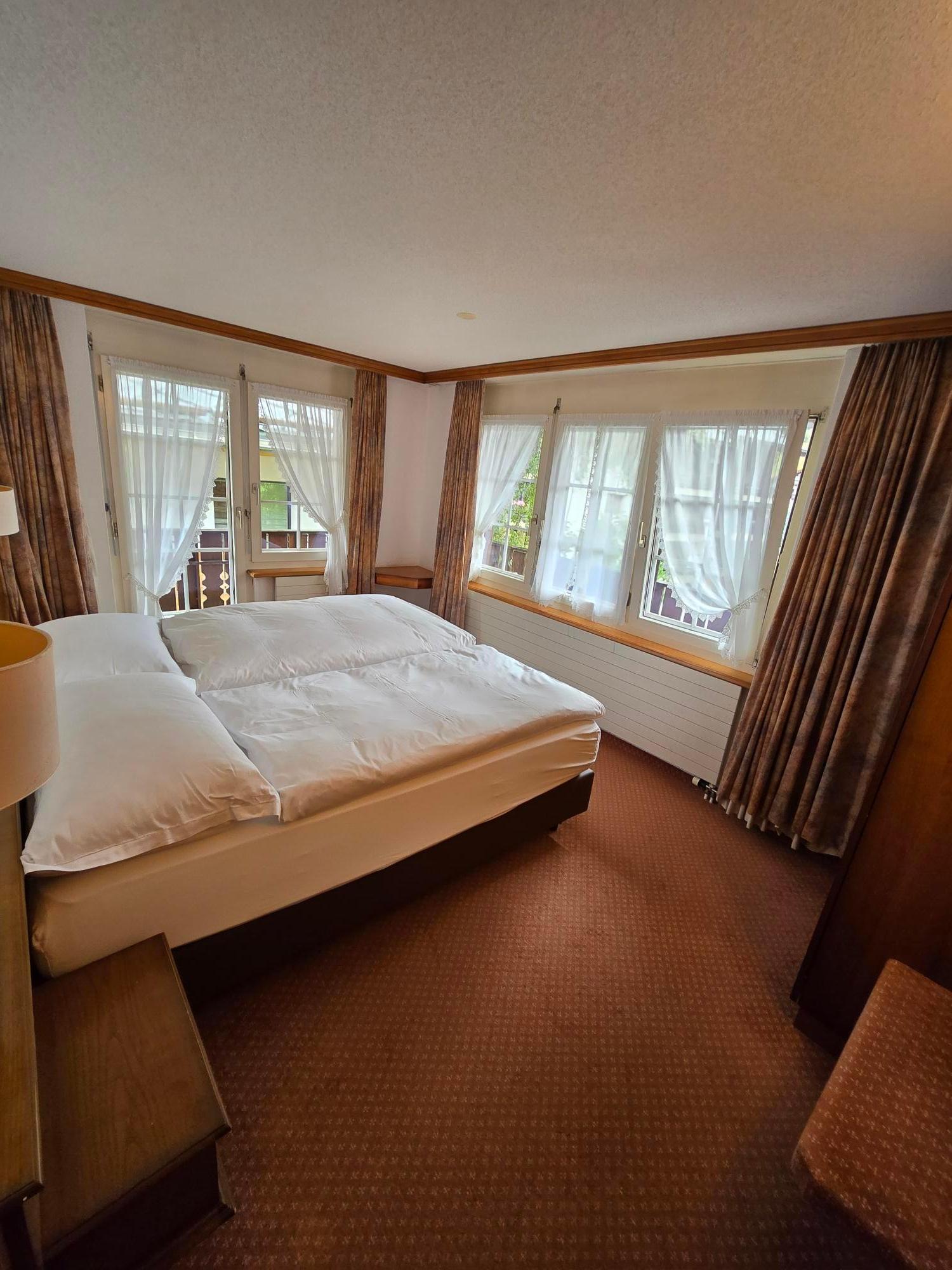 Spacious comfortable bedroom, with balcony access on the far side of the bed.