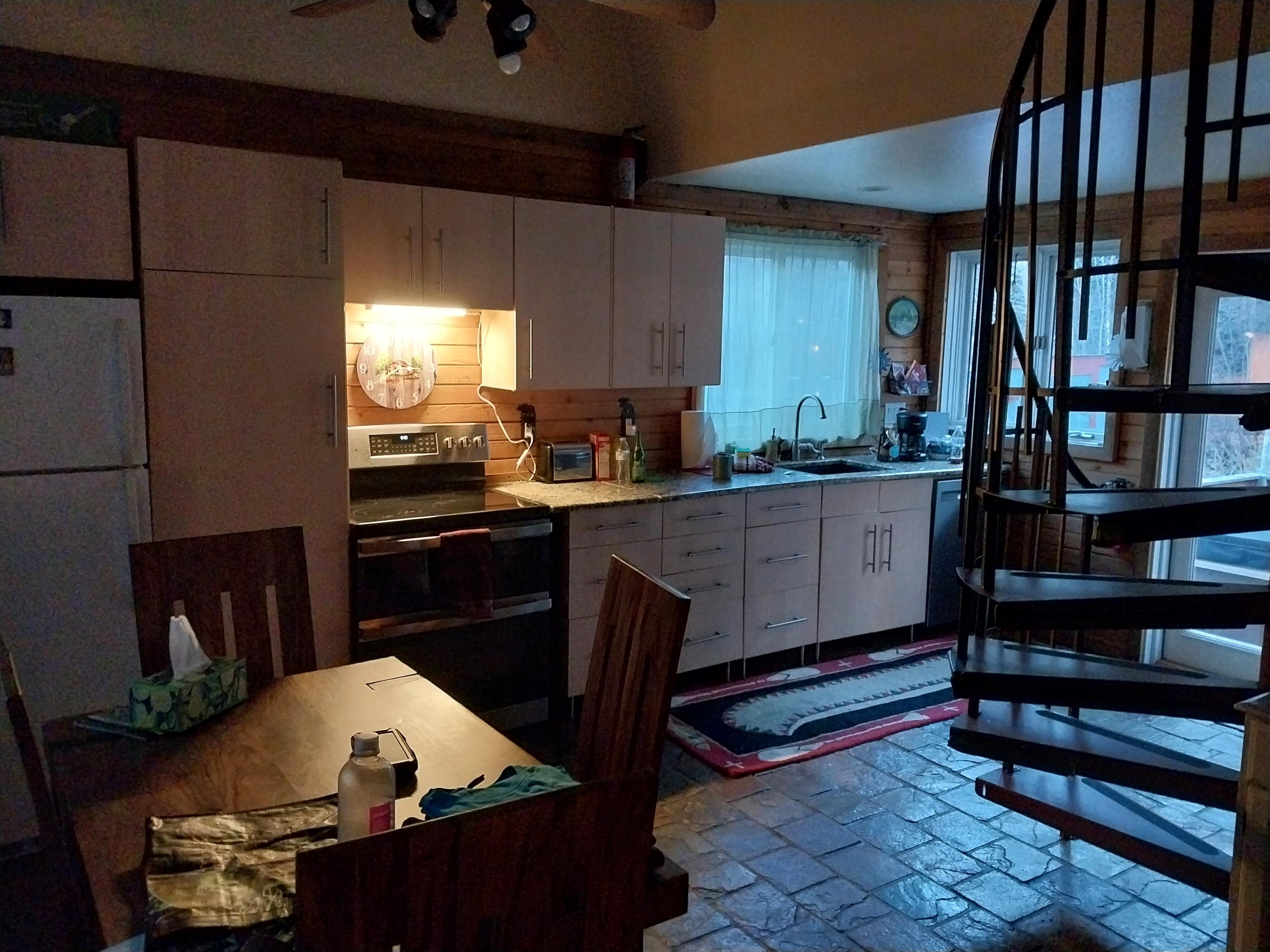 The quaint kitchen dining are is perfectly stocked and played out for a food gathering place and openess to allow visiting with anyone in the living room anointed as well. 