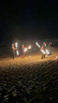 Fire show entertainment on the beach restaurant one night