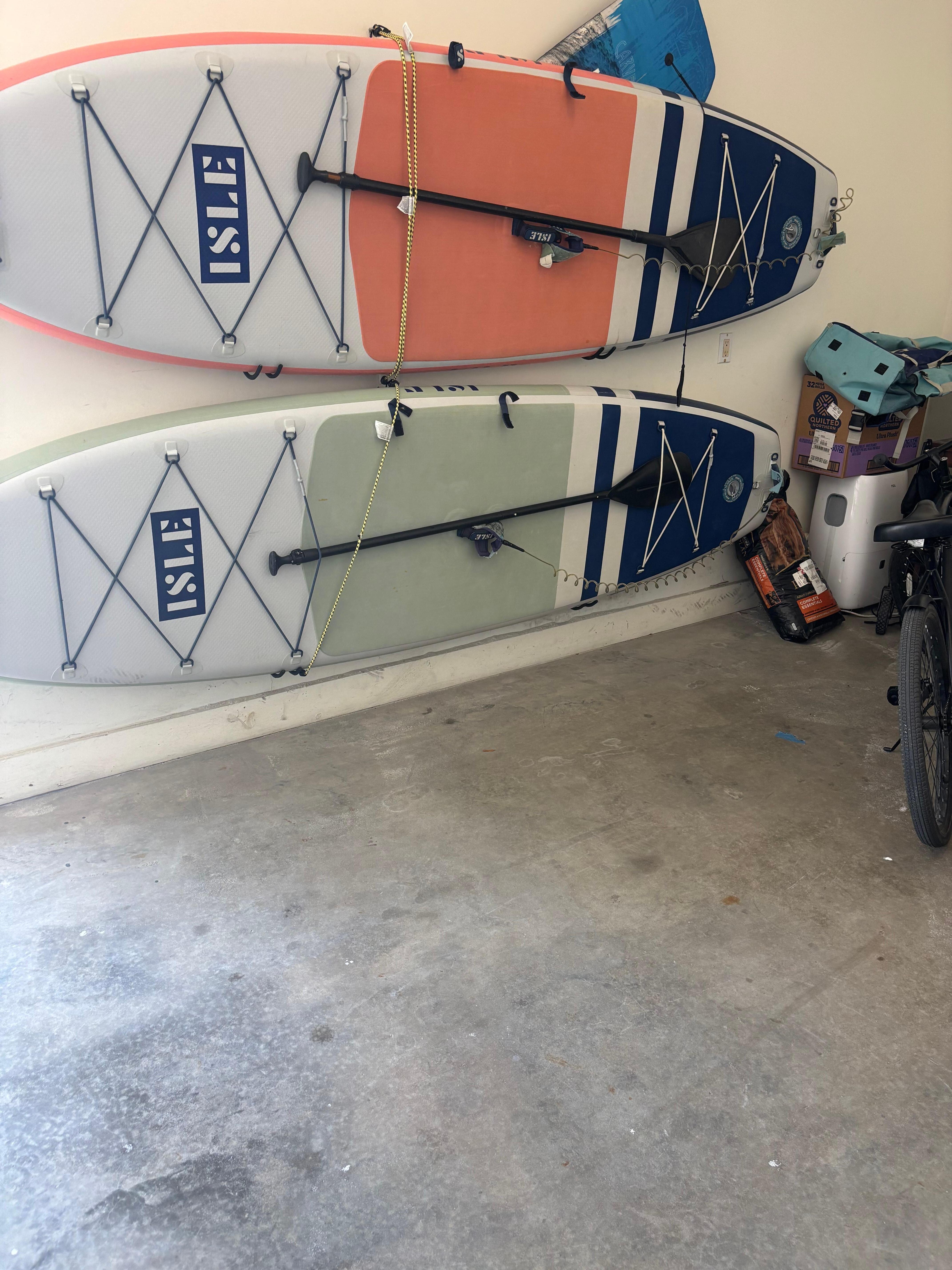 Paddle boards and garage floor after cleanup up.