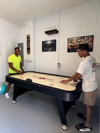 Air hockey and foosball table located in the detached garage of the townhome