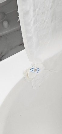 Medical waste stuck to shower curtain. How do you miss this if you clean the room?