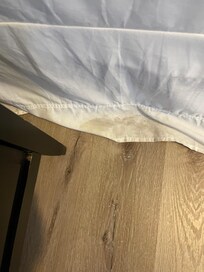 Very dirty floor and bed skirting.