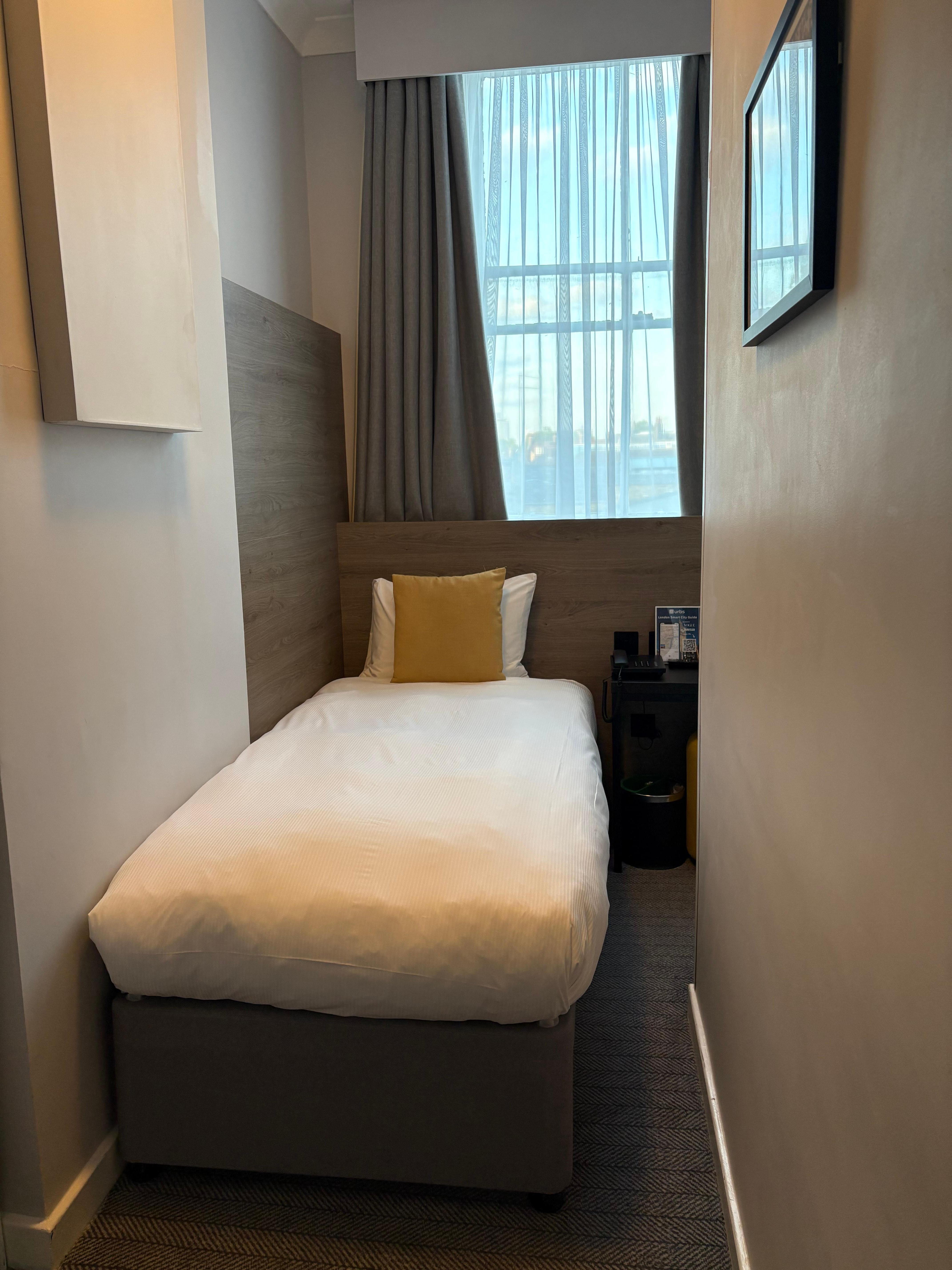 Single room. Bathroom is right hand side of window, accessed by this small gap between bed and wall.
