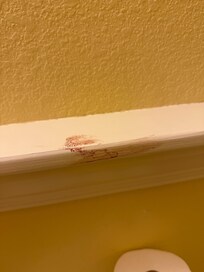 Blood on trim in bathroom.
