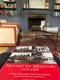 Reading a book about Missouri Historic homes on the comfy leather couch.