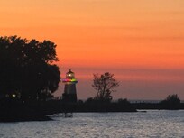 Sunset silhouetting the lighthouse