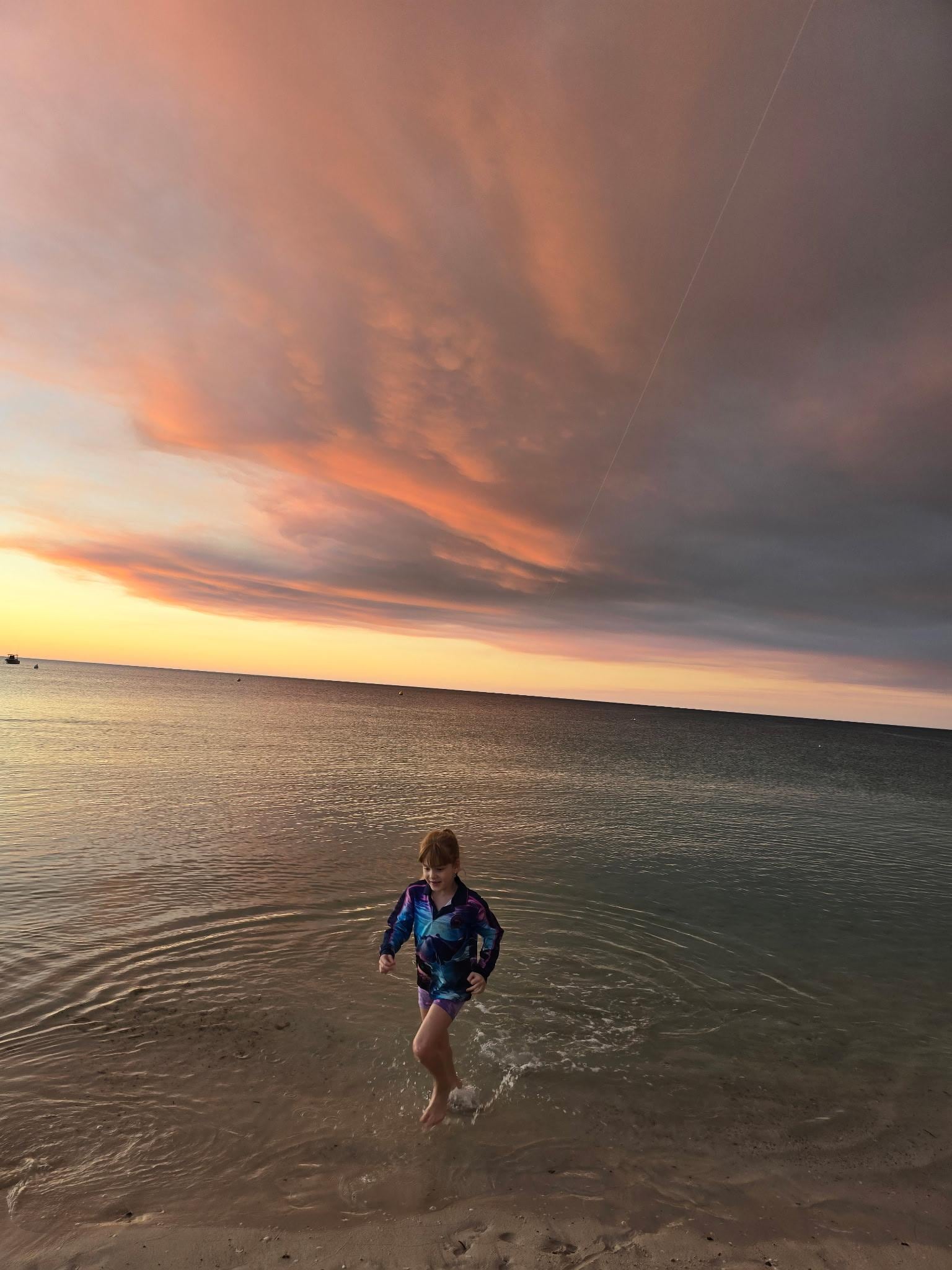 Olivia playing at the beach with some awesome sky backdrops 