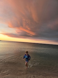 Olivia playing at the beach with some awesome sky backdrops