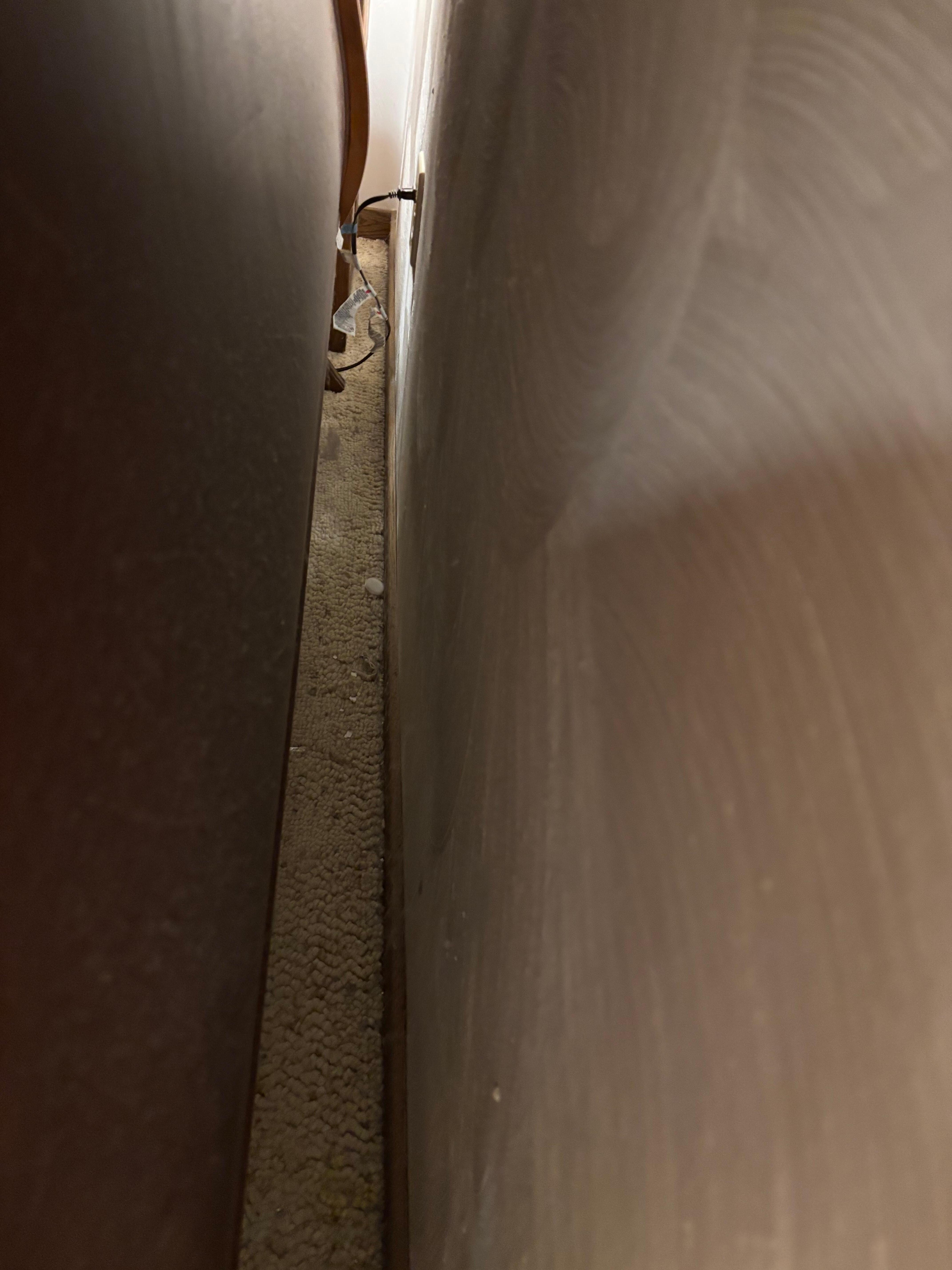 Behind bed in master bedroom 