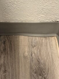 Hair and dust in the corners of the floor