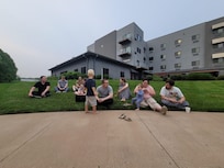 Enjoying the lawn at the back of the hotel.   At night it is GORGEOUS w/ a lit-up waterfall in the distance.