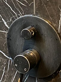 Small knob is missing from upper knob in shower making it difficult to regulate the shower