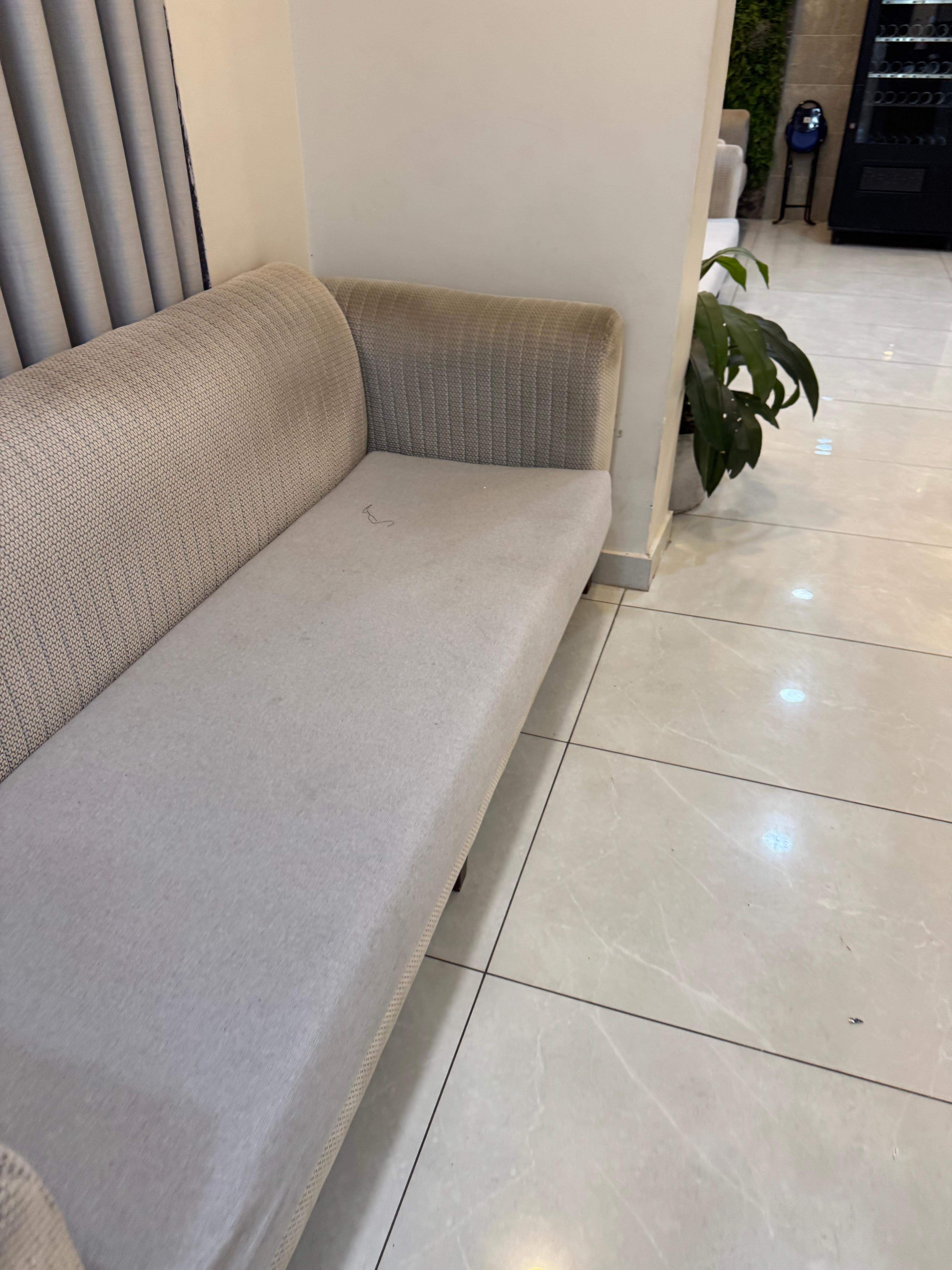 Reception with dirty and stained couches 