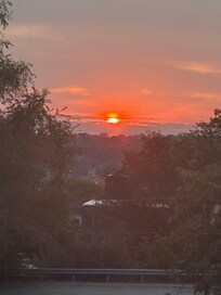 View of sunrise from living room window.