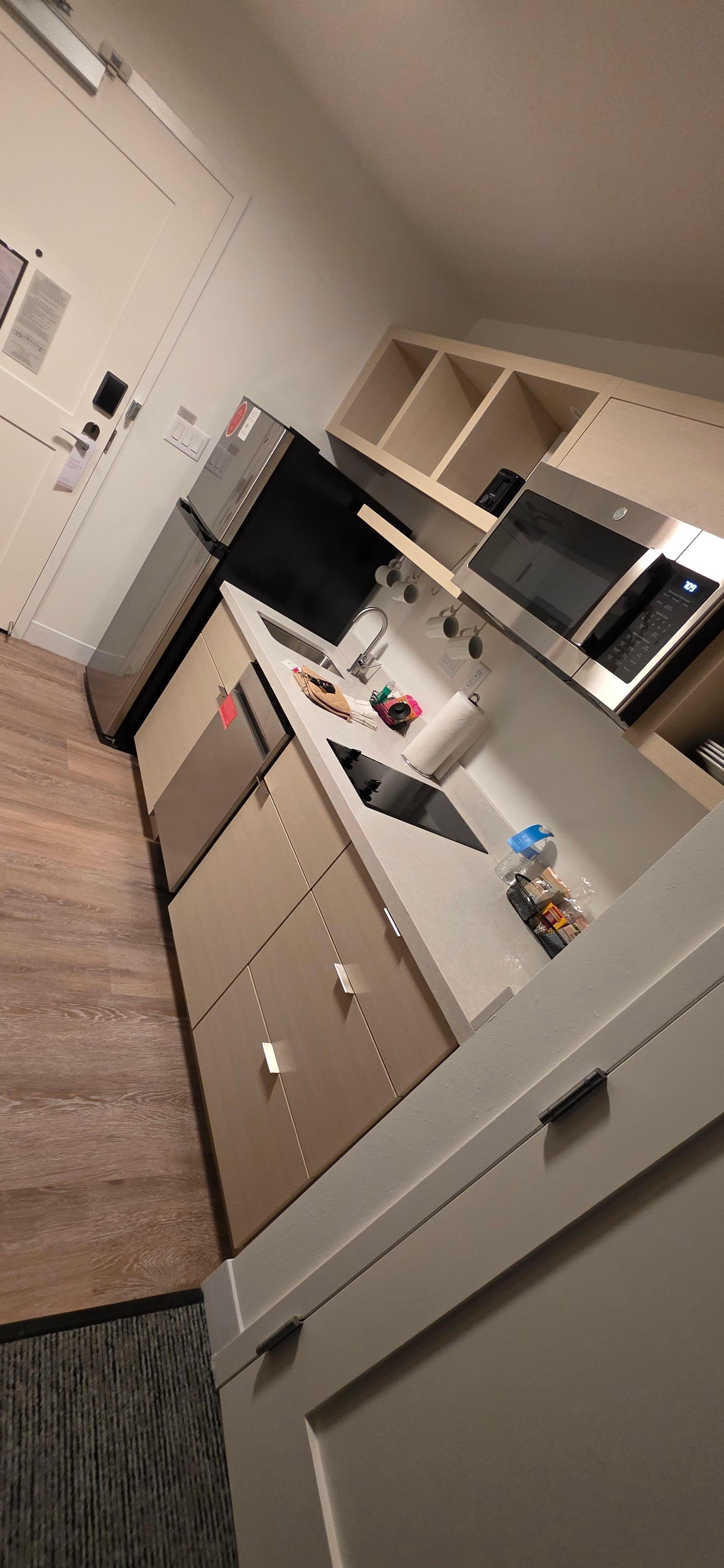 Stocked supplies in kitchen. Dishwasher, sink, fridge/freezer (ice trays included), toaster, standard hotel coffee machine, two top flat stove burners, cups, plates, bowls, strainer, silverware, etc, kitchen towels and pot holders, dish soap, etc