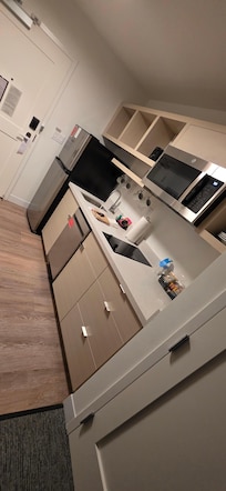 Stocked supplies in kitchen. Dishwasher, sink, fridge/freezer (ice trays included), toaster, standard hotel coffee machine, two top flat stove burners, cups, plates, bowls, strainer, silverware, etc, kitchen towels and pot holders, dish soap, etc