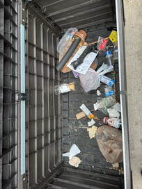 Trash filled with unbagged rotting garbage